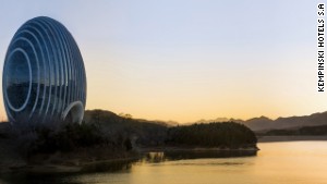 Glass panels on the Kempinski Sunrise Hotel reflect the nearby mountains, sky and lake. 