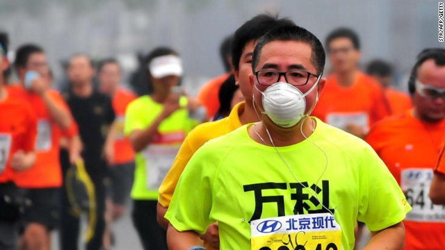 Runners wore face masks and were supplied with thousands of sponges on the course by organizers in the less than ideal conditions for a marathon.