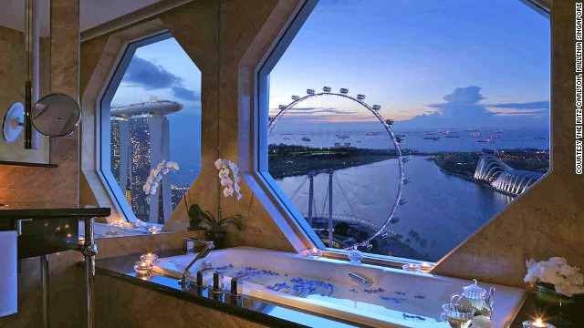 Marble bathrooms in the Ritz-Carlton, Millenia Singapore's bay view rooms overlook the iconic Marina Bay Sands, Singapore Flyer and city skyline.