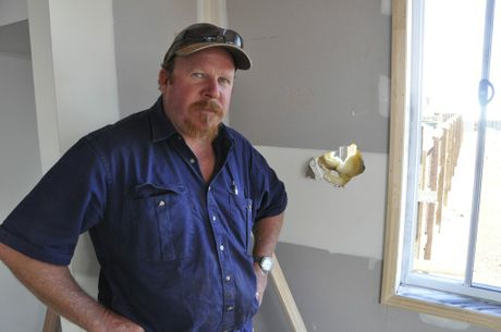 Toowoomba builder Stuart Hopkins inspects where thieves broke into a Greenwattle St house to steal his tools. 