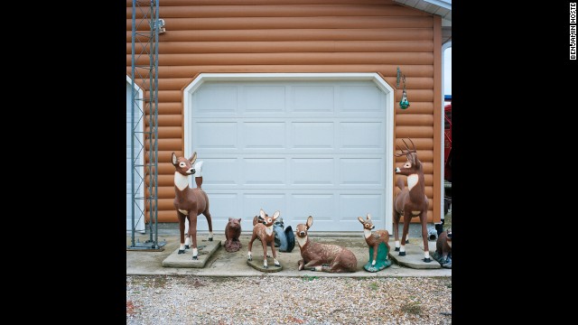 Ceramic lawn ornaments sit in front of Arrington's garage.