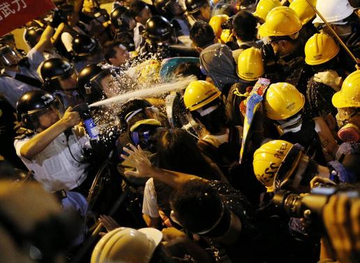 Police use pepper spray during clashes with pro-democracy protesters close to the chief executive office in Hong Kong, November 30, 2014. REUTERS/Tyrone Siu