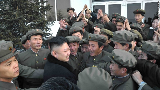 In a photo released by the official North Korean news agency in December 2012, Kim celebrates a rocket's launch with staff from the satellite control center in Pyongyang, North Korea.