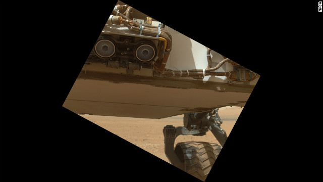 This view of the lower front and underbelly areas of NASA's Mars rover Curiosity was taken by the rover's Mars Hand Lens Imager. Also visible are the hazard avoidance cameras on the front of the rover. 