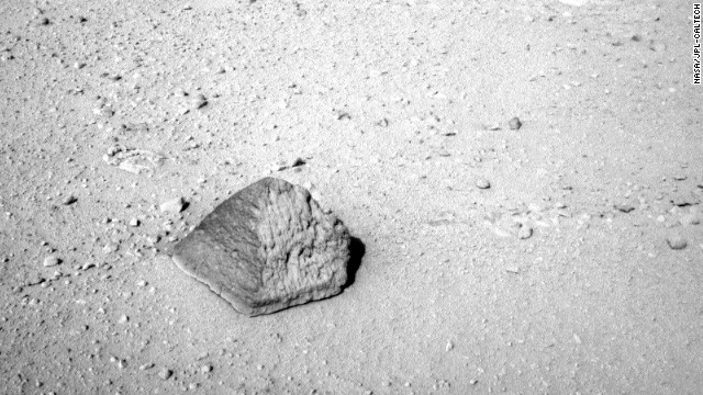 This rock will be the first target for Curiosity's contact instruments. Located on a turret at the end of the rover's arm, the contact instruments include the Alpha Particle X-Ray Spectrometer for reading a target's elemental composition and the Mars Hand Lens Imager for close-up imaging. 