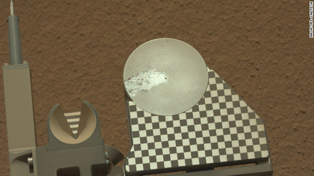 The robotic arm on NASA's Mars rover Curiosity delivered a sample of Martian soil to the rover's observation tray for the first time on October 16, 2012.
