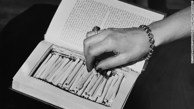 Marijuana cigarettes are hidden in a book circa 1940. Congress passed the Marijuana Tax Act in 1937, effectively criminalizing the drug.