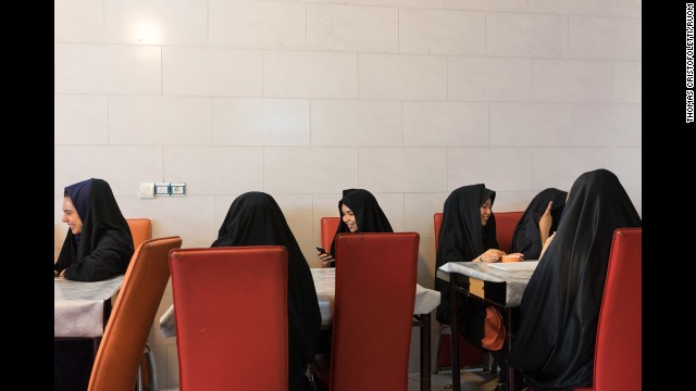 Young women eat ice cream at a cafe in Qom, Iran.