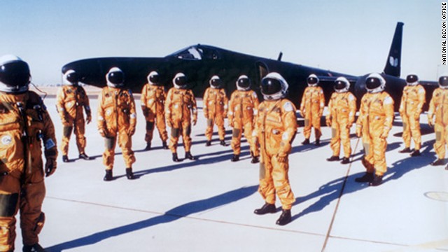 CIA pilots stand in pressure suits in front of a U-2 plane. The pilots needed the pressure suits for the extremely high altitudes.