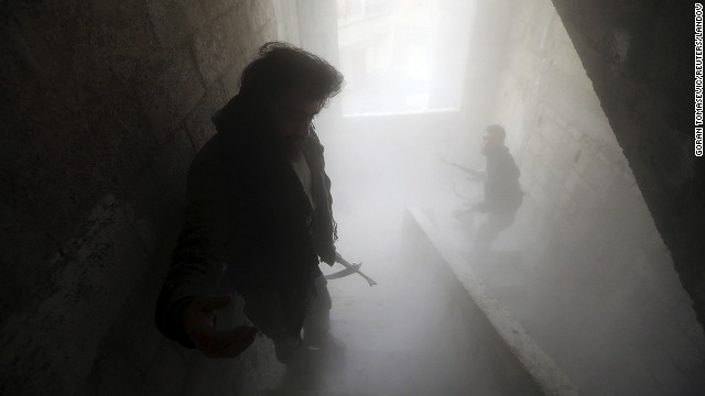 Free Syrian Army fighters walk through a dust-filled stairwell in Damascus on February 7.