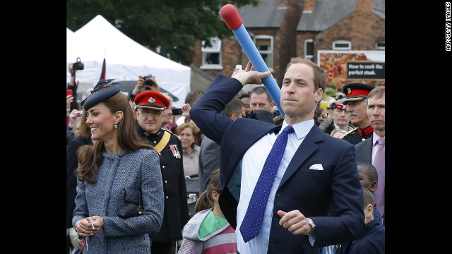 Prince William throws a foam javelin as his wife, now the Duchess of Cambridge, stands at his side during a visit to Nottingham, England, on June 13, 2012. The couple were in the city as part of Queen Elizabeth II's diamond jubilee tour, marking the 60th anniversary of her accession to the throne.