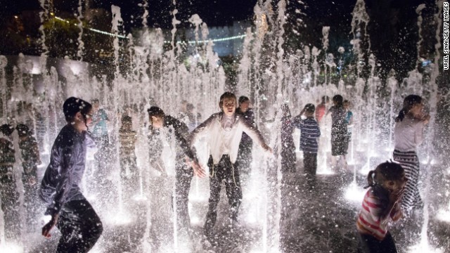 Children play in a fountain at a park in Jerusalem.