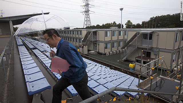 A employee of the Tokyo Electric Power Company walks up stairs near temporary housing built for workers who live at J-Village, at the former soccer training complex.