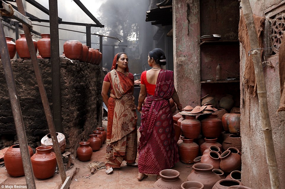 People in Dharavi slum in Mumbai work hard, producing mostly recycled articles and pottery. The posture of these two women at the local pottery store, taking a short break for conversation, express dignity, while the colours of their saris perfectly blend with the scenery