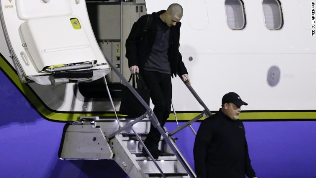 Matthew Miller, top, walks off the plane after arriving back in the United States.