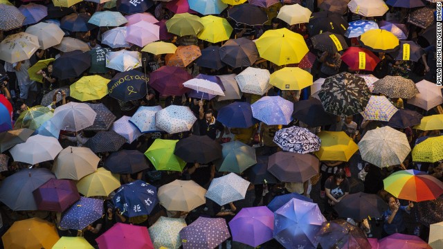 People open umbrellas at the main protest site in Hong Kong on Tuesday, October 28. The umbrella has become the defining image of the protest movement, used to shield protesters from tear gas and the elements. 