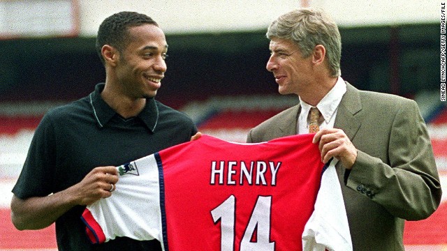 After a year with Juventus, Henry's career took off when he signed for English side Arsenal in 1999. Here, he holds his newly pressed shirt with Arsenal manager Arsene Wenger at the North London club's old ground, Highbury. 