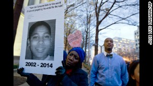 A demonstrator in Washington holds a picture of Tamir Rice on December 1 at a protest about a different case: last month\'s decision by a grand jury not to indict a police officer in the shooting death of Michael Brown in Ferguson, Missouri.