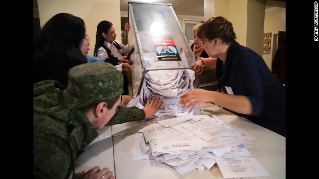 Election officials empty a ballot box in Donetsk on November 2.