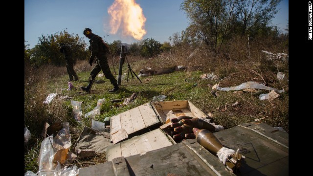 Pro-Russian rebels fire mortars toward Ukrainian positions close to the Donetsk airport on October 8.