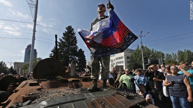 A pro-Russian rebel delivers a speech atop a damaged Ukrainian armored personnel carrier in Donetsk on August 24. Ukraine has recently retaken control of much of its eastern territory bordering Russia, but fierce fighting for the rebel-held cities of Donetsk and Luhansk persists.