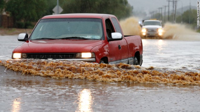 People attempt to drive their vehicles through severely flooded streets in Phoenix on September 8. 