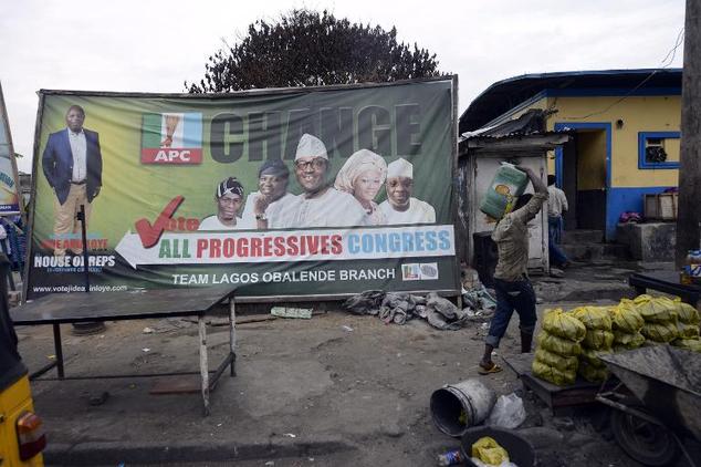 A man walks past a billboard of the main opposition All Progressives Congress (APC) presidential candidate Mohammadu Buhari in Lagos, on March 31, 2015