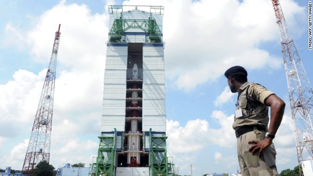 An Indian security forces member watches the PSLV-C25 launch vehicle carrying the Mars Orbiter probe as its payload on October 30, 2013.