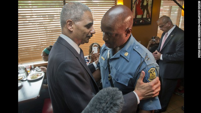 Holder talks with Capt. Ron Johnson of the Missouri State Highway Patrol in Ferguson, Missouri, in August. Holder traveled to Ferguson to oversee the federal government's investigation into a police officer's shooting of 18-year-old Michael Brown.