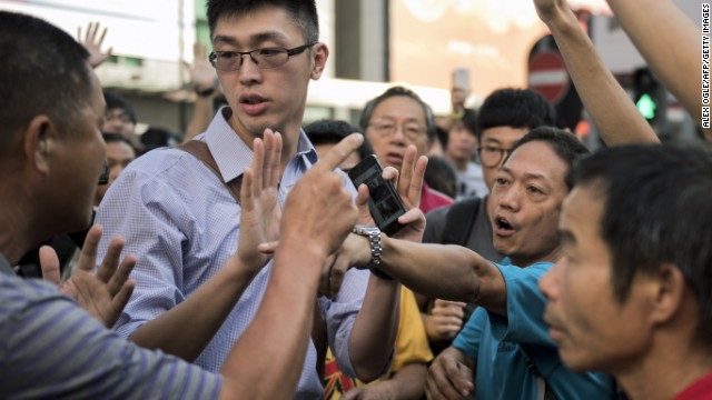 Pro-democracy protesters argue with a man, left, who opposes the occupation of Nathan Road in Hong Kong on September 29. 