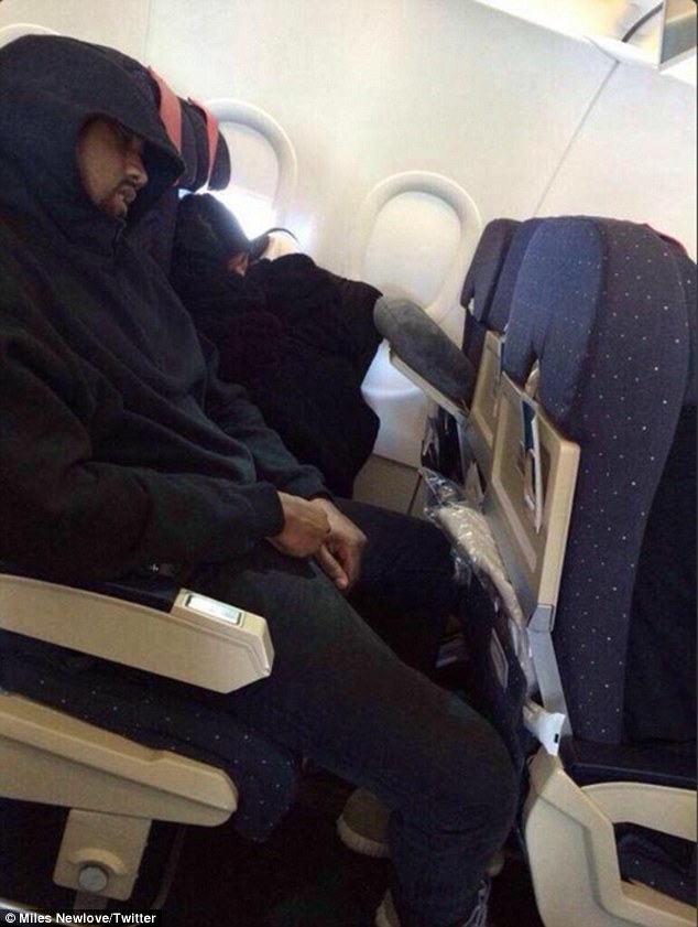 Caught in the act: Kanye West and Kim Kardashian were snapped sleeping in economy class on their flight to Armenia earlier this month