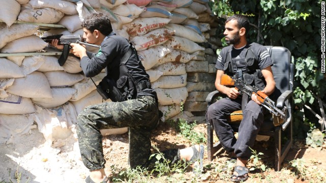 Syrian opposition fighters take position behind sandbags in Aleppo, Syria, on Thursday, September 11.