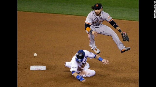 Kansas City Royals' Alex Gordon is out at second as Brandon Crawford of the San Francisco Giants turns a double play on a ball hit by Salvador Perez during the fourth inning of Game 7 of the World Series on October 29, in Kansas City, Missouri.