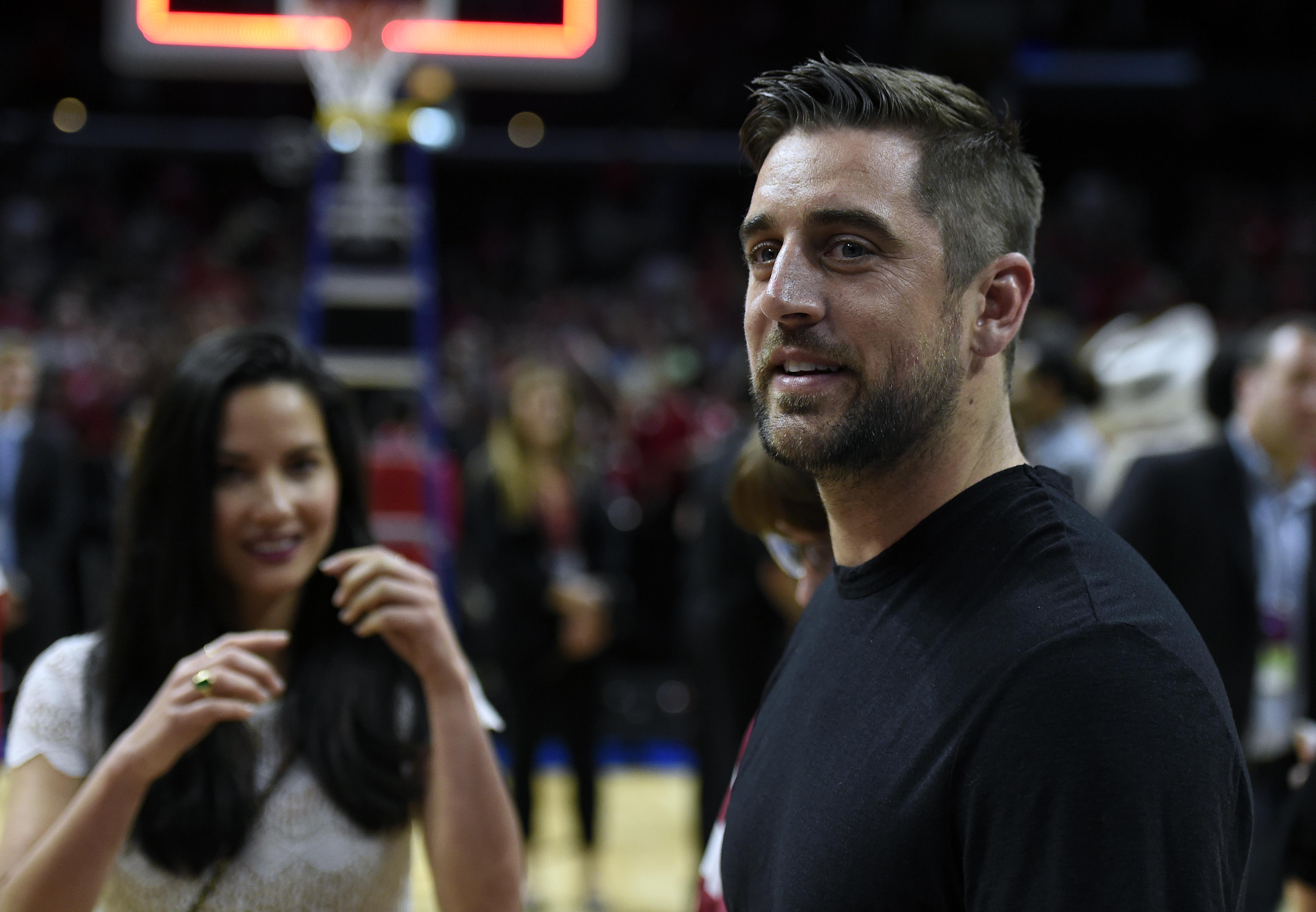 Mar 28, 2015; Los Angeles, CA, USA; Green Bay Packers quarterback Aaron Rodgers and film actress Olivia Munn in attendance during the 85-78 Wisconsin Badgers victory against Arizona Wildcats in the finals of the west regional of the 2015 NCAA Tournament at Staples Center. (Robert Hanashiro-USA TODAY Sports)