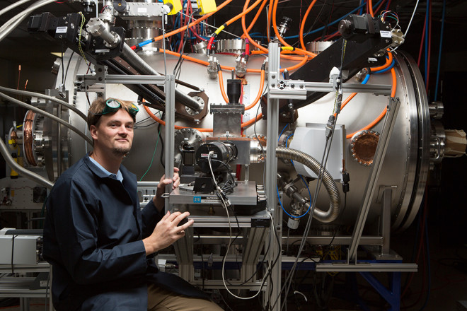 Program manager Tom McGuire looks into the T-4 chamber, which is the fourth iteration of the Skunk Works’ compact fusion reactor experiment