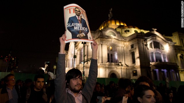A protester holds up a poster parodying Mexico's President Enrique Peña Nieto during a rally in Mexico City on November 20.
