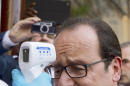 French President Francois Hollande has his temperature measured upon his arrival at the Donka hospital in Conakry, Guinea, Friday, Nov. 28, 2014, as part of a one day visit in Guinea focused on Ebola situation. Hollande is set to become the first Western head of state to visit one of the west African countries worst hit by Ebola as he flies into Guinea for a brief stopover.(AP Photo/Alain Jocard,Pool)