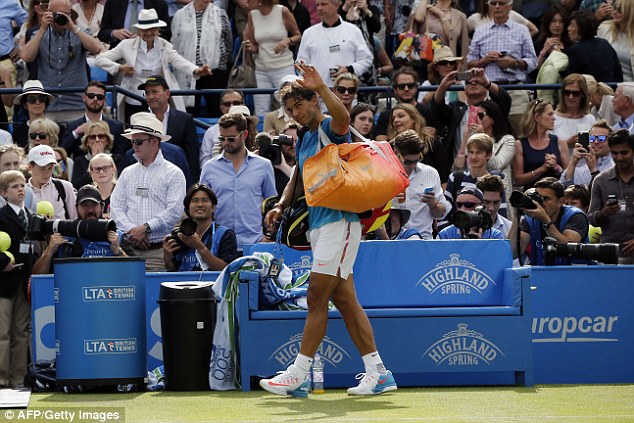 Nadal waves to the crowd as he leaves the court following his shock defeat by Dolgopolov