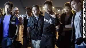 Protester Ken Tsang is led away by police ahead of an alleged assault on October 15.