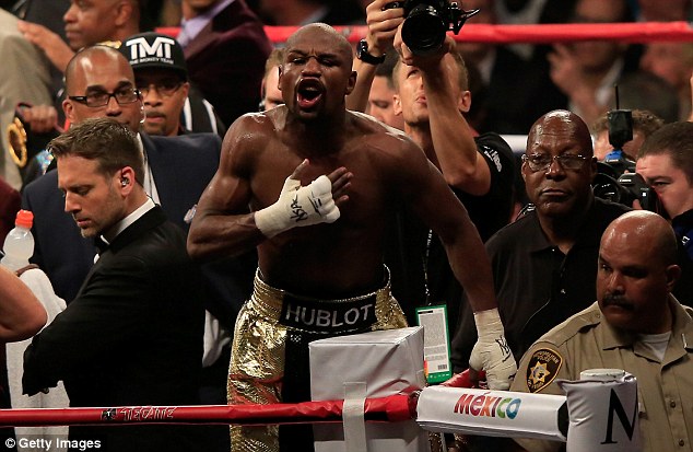 Mayweather pumps his chest after the judges deem him the winner of his fight against Pacquiao 