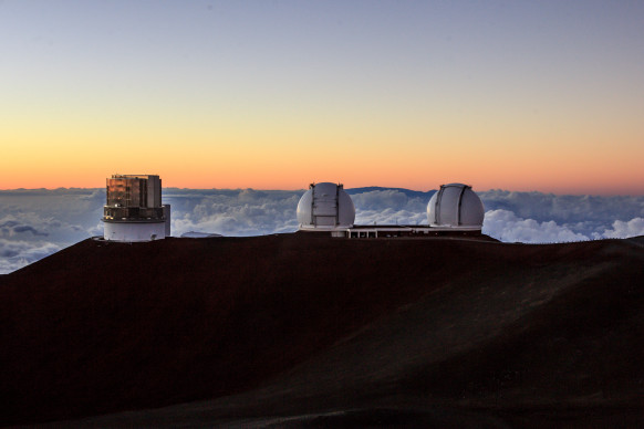 The Subaru, Keck I and Keck II Telescopes at the Mauna Kea Observatories at Sunset on the Big Island of Hawaii.