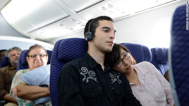 Alex Gilbert and Rebecca Davila watch a film during a flight on a Boeing 787 Dreamliner. 