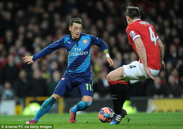 Ozil (left) takes on Manchester United's Phil Jones during the FA Cup sixth-round clash on Monday