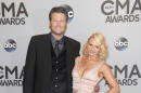 File-This Nov. 5, 2014, file photo shows Blake Shelton, left, and Miranda Lambert arriving at the 48th annual CMA Awards at the Bridgestone Arena in Nashville, Tenn. Shelton may be going into Academy Country of Music Awards as a host, performer and two-time nominee, but he has another priority: being a cheerleader. Shelton’s wife, fiery country star, Lambert, is the top contender with eight nominations, including the coveted entertainer of the year, an award she has yet to win.(Photo by Evan Agostini/Invision/AP, File)