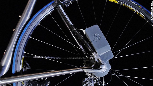 The tiny Atom bike-powered generator fits to a rear wheel, where it converts revolutions into enough juice to amp up any USB-charged gizmo.