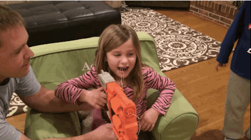 funny parenting gif little girl shoots her loose tooth out