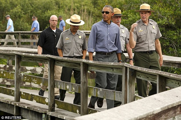 President Barack Obama takes a walking tour of the Anhinga Trail at Everglades National Park. Obama visited the subtropical swamps of the park today as part of a push to get Americans thinking and talking about the damage climate change is causing close to home