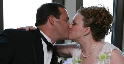 Husband and Wife Kissing at Wedding