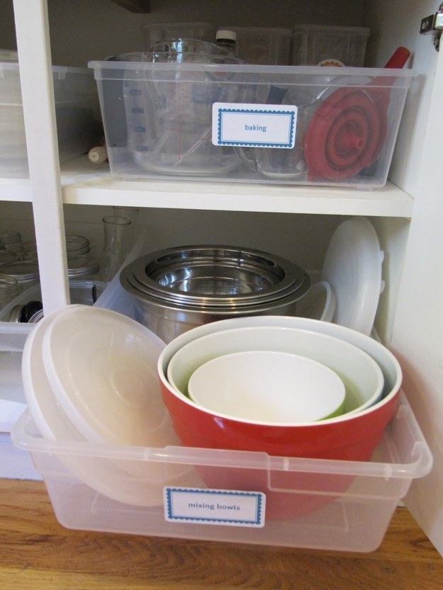 Pick your messiest kitchen cabinet, and use inexpensive plastic bins as faux pull-out drawers.