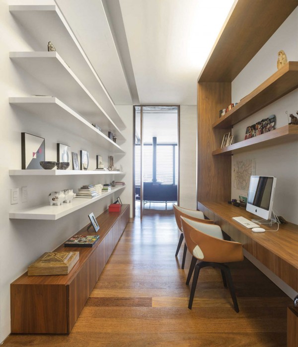While the office is a smaller space, it is well organized with plenty of open shelving and ambient lighting without being harsh. It's set away from the living areas as to lend a sense of solitude for concentration, but it's still easily accessible and flows seamlessly through the rest of the ground floor design.
